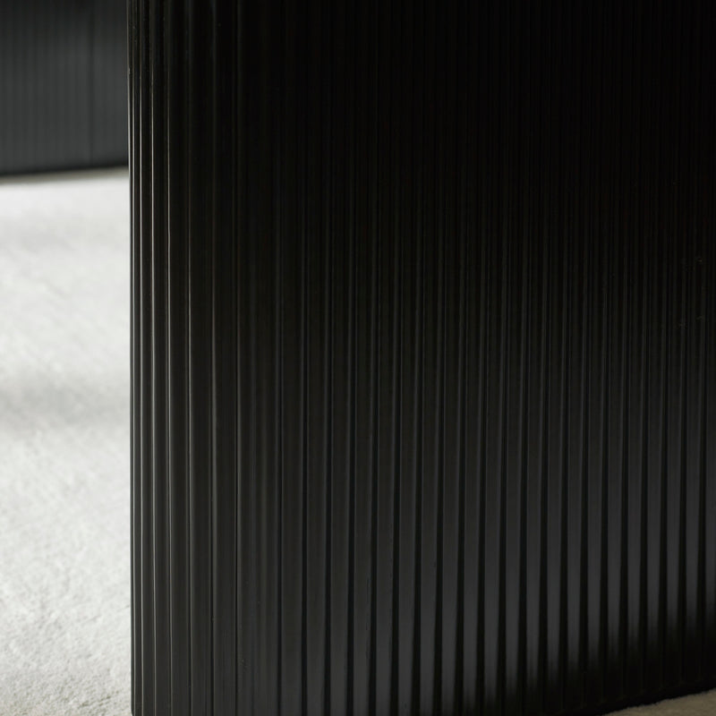 Close-up of black fluted pedestal of Bolivia Oval Dining Table 