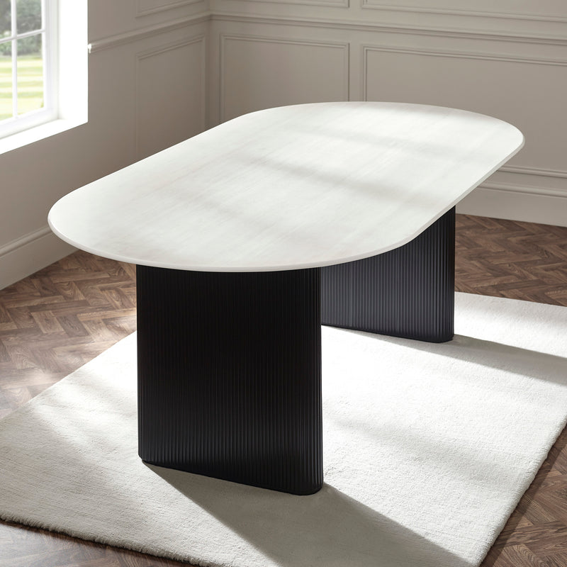 Bolivia white marble effect oval dining table styled on a white rug over parquet wooden flooring