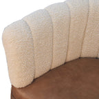 Close-up detail of the cream bouclé channel-tufted backrest texture on the accent chair.