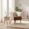 Bouclé Cream and Leather Accent Armchair styled in a bright living room next to a wooden side table.