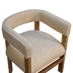 Side angle view highlighting the angled solid mango wood frame and sculpted armrests.