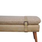 Close-up detail of the beige leather buckle strap and studded trim on the bouclé seat.