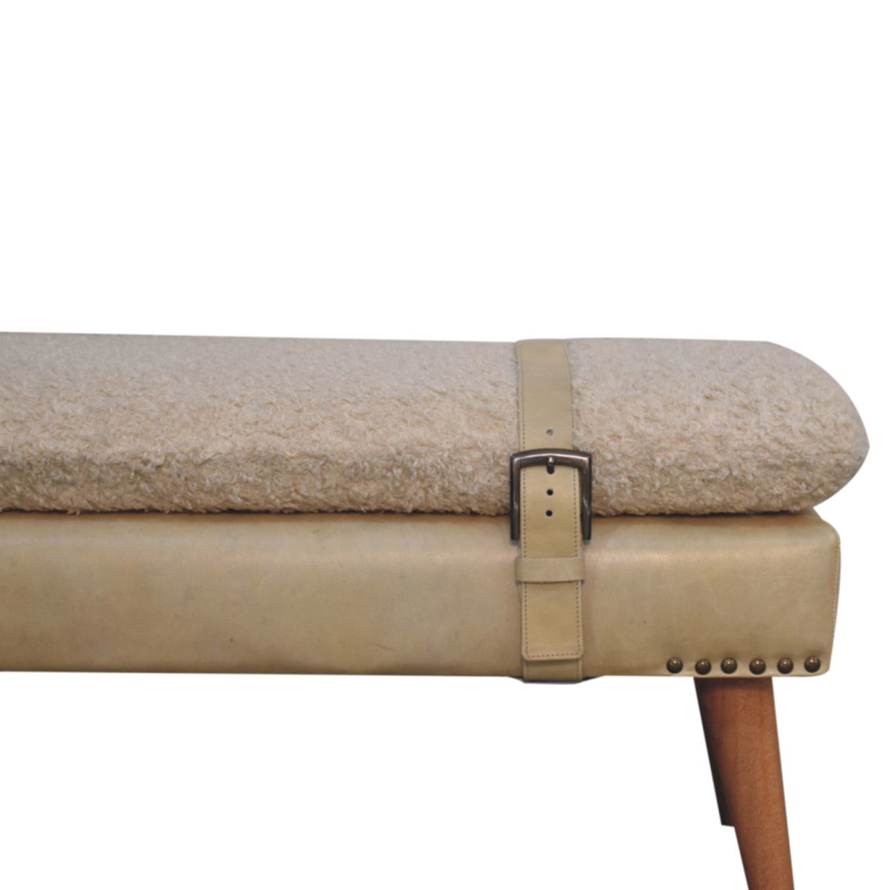 Close-up detail of the beige leather buckle strap and studded trim on the bouclé seat.