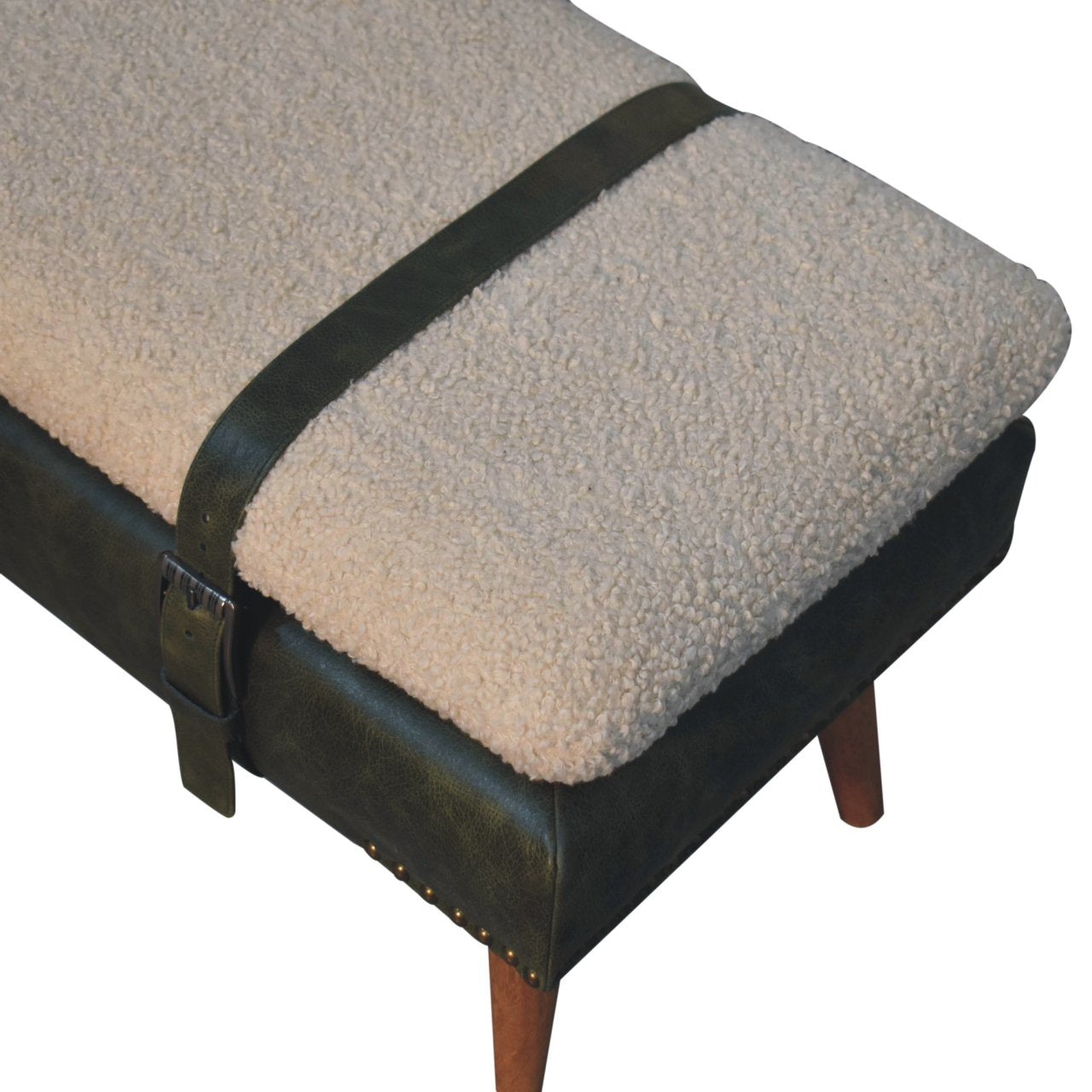 Top angle view showing the black leather straps wrapping over the plush cream bouclé seat.