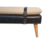 Side profile detail showing the black leather trim and tapered solid wooden legs.
