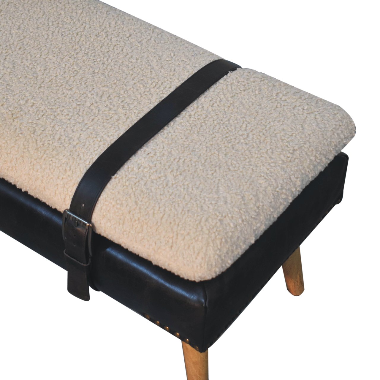 Top angle view showing the black leather harness strap contrasting with the bouclé cushion.