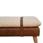 Side profile view showing the brown leather trim and soft cream bouclé seat cushion.