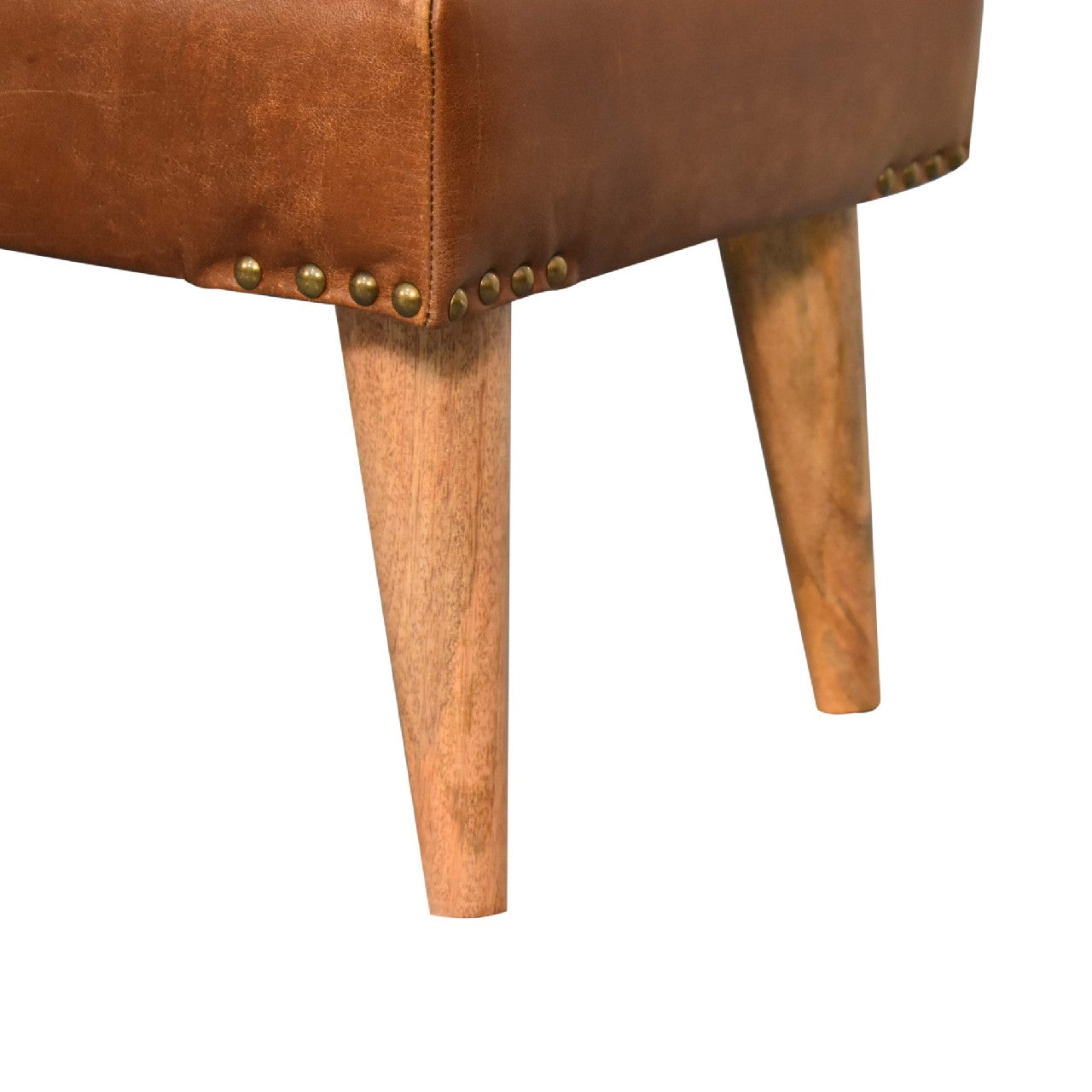 Close-up detail showing the stud embellishments and tapered wooden legs on the brown leather base.