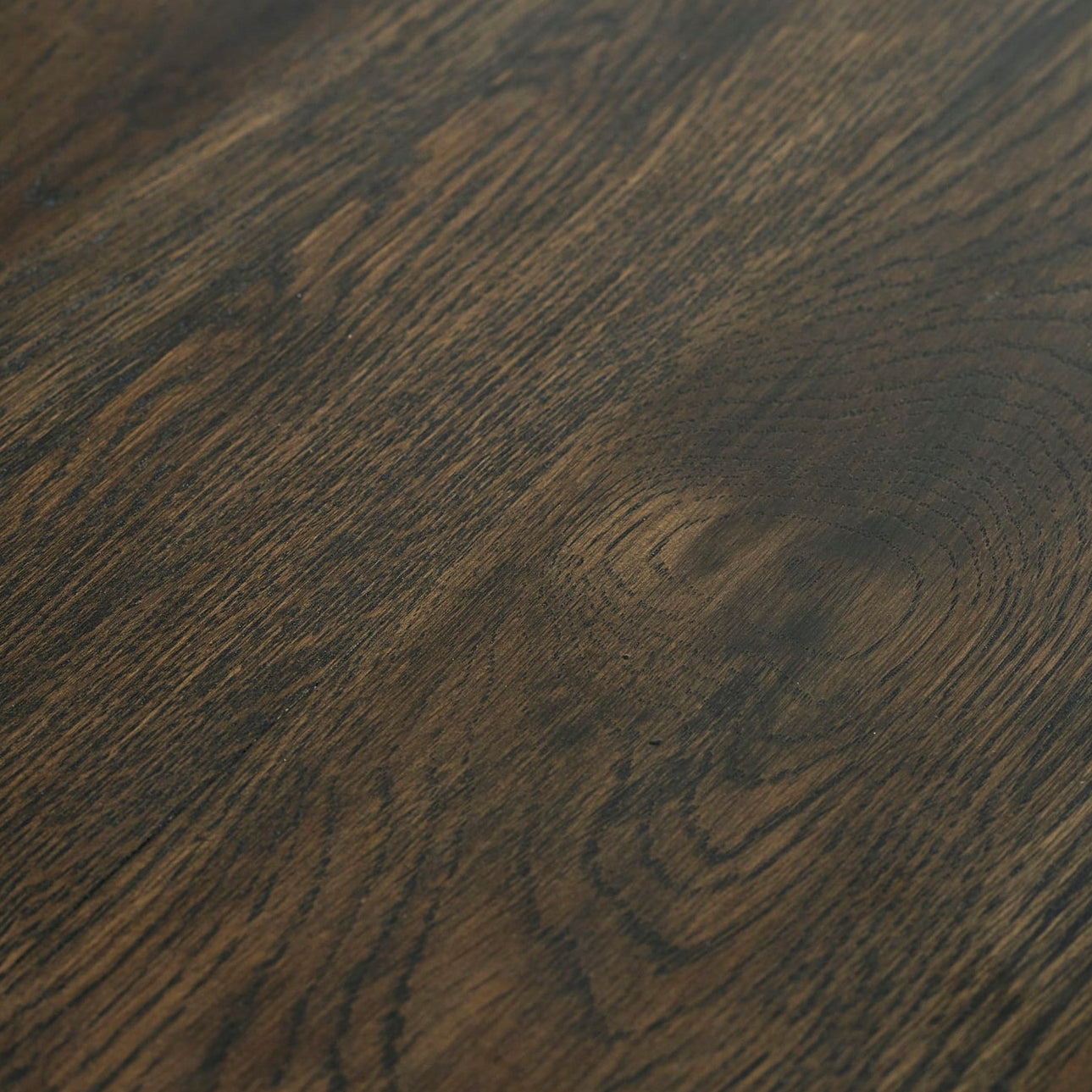 Close-up detail of the rich dark oak wood grain finish on the Brooklyn bar table top.