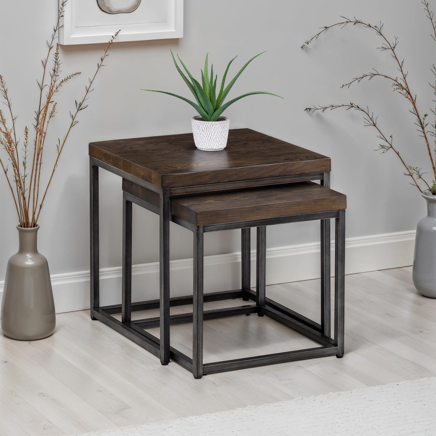 Brooklyn dark oak nesting lamp tables placed in a styled home setting with decorative greenery