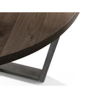 Close-up detail of the circular dark oak tabletop edge and metal support frame.