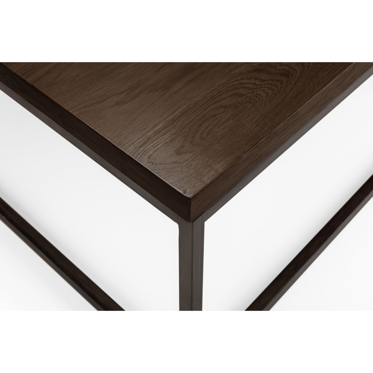 Close-up detail of the dark oak wood grain top and black metal frame corner.