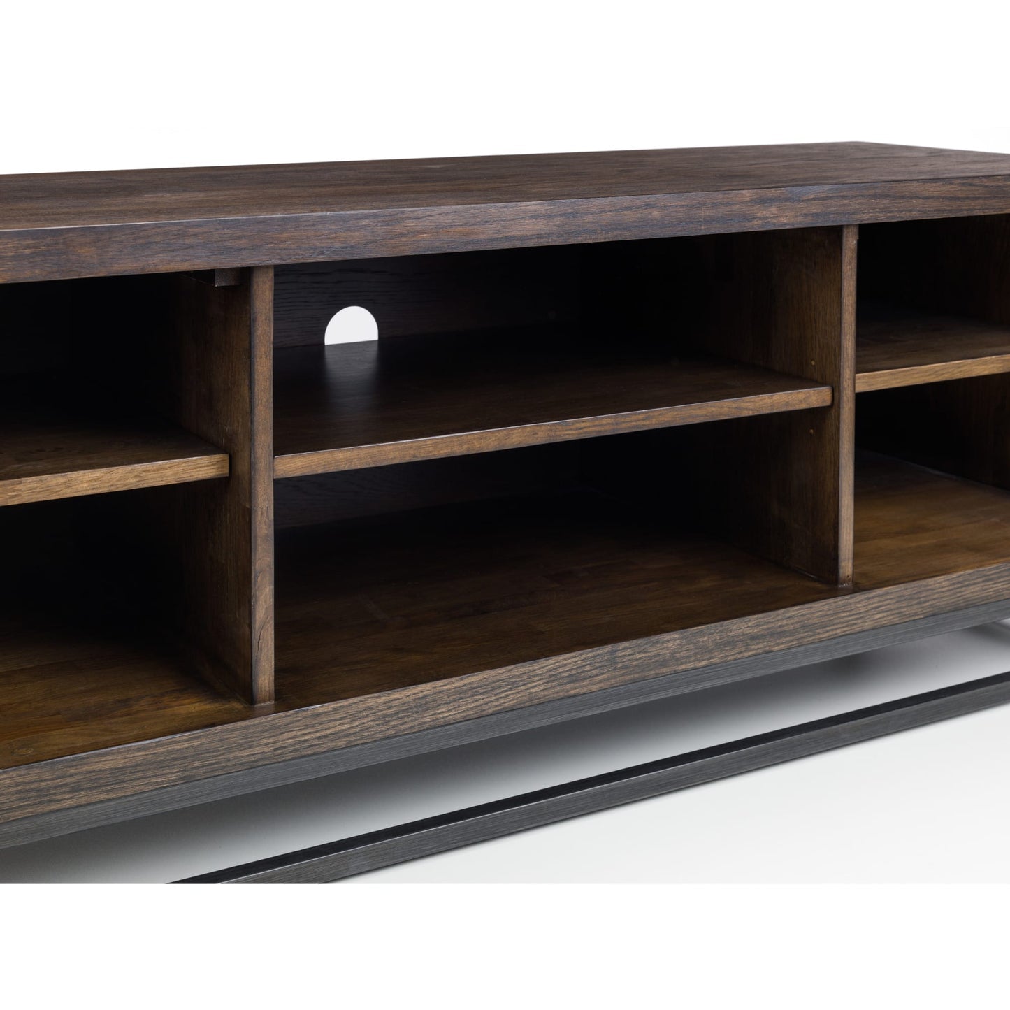 Close-up detail of the central open shelves and cable management hole on the Brooklyn dark oak TV unit