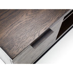 High-angle close-up view showing the dark oak wood grain finish and sleek metal hardware