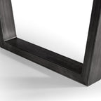 Close-up detail of the black powder-coated metal U-shaped leg base on the Brooklyn dining table.