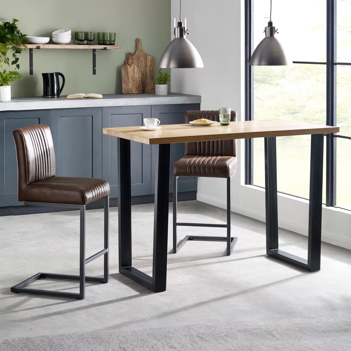 Brooklyn industrial solid oak bar table styled with brown leather bar stools in a kitchen diner setting.