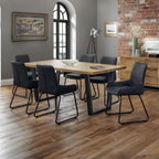 Brooklyn natural oak dining table styled with upholstered dining chairs in a modern home.