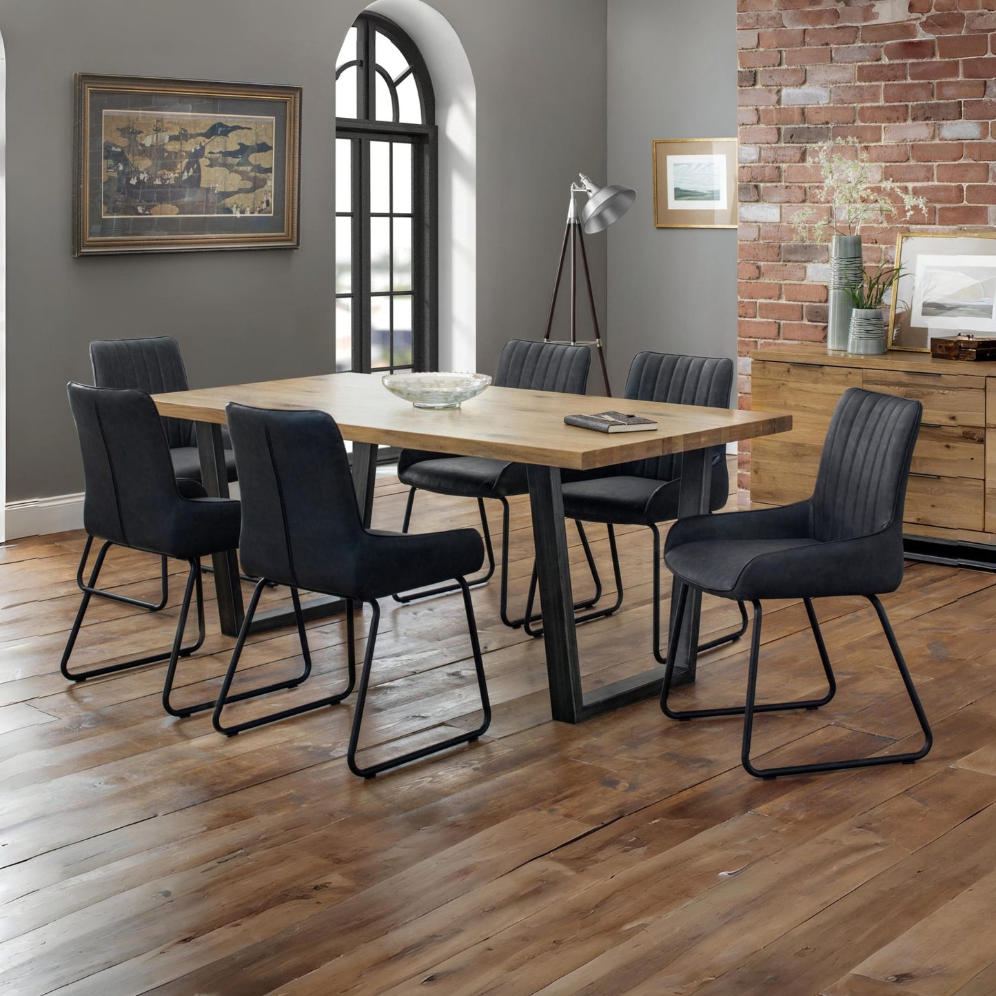 Brooklyn natural oak dining table styled with upholstered dining chairs in a modern home.