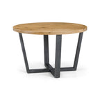 Studio view of the Brooklyn round dining table with natural oak top and black powder-coated legs.