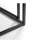 Detailed close-up showing the sturdy black metal leg joinery and frame construction
