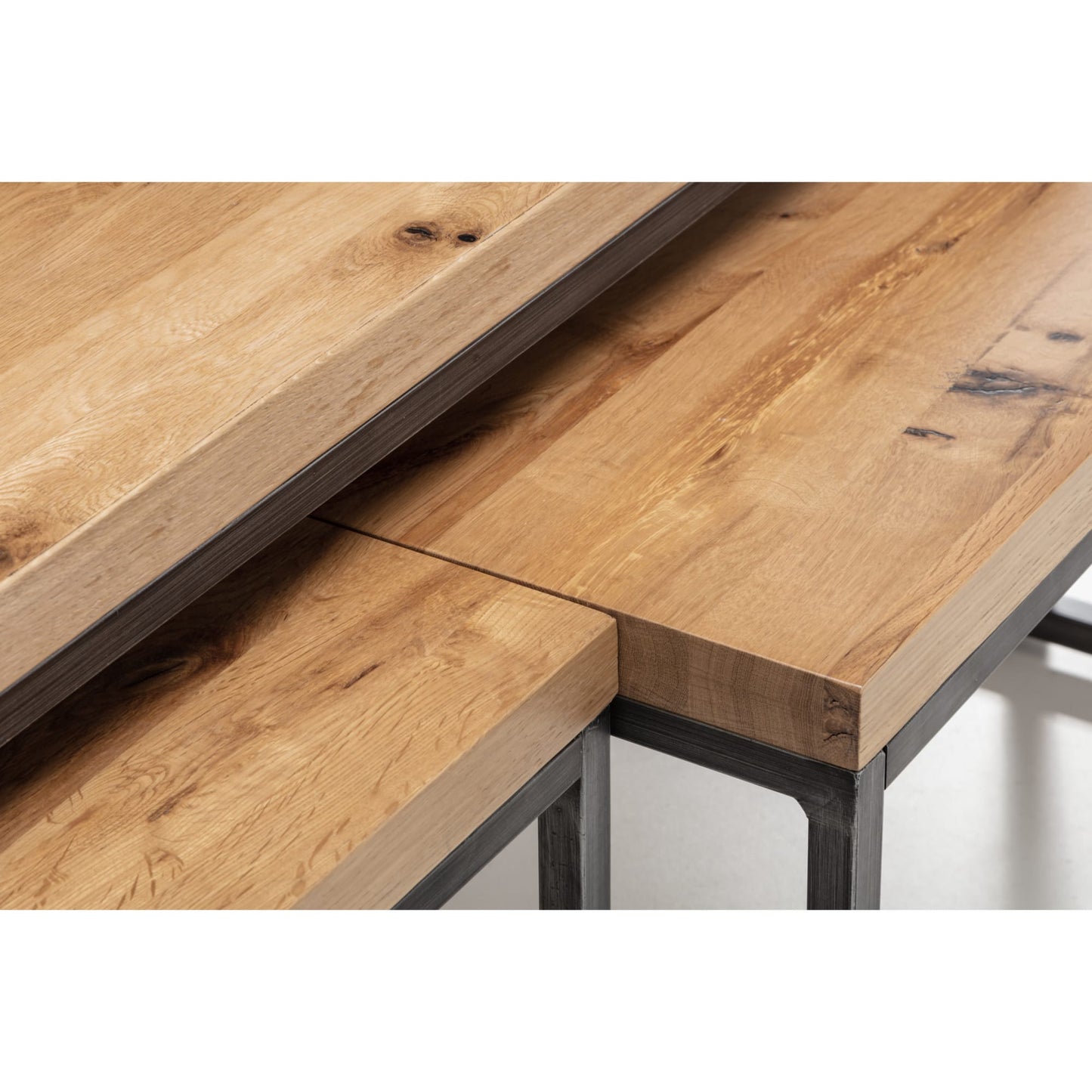 Close-up detail of the natural rustic wood grain on the Brooklyn oak nesting coffee table tops