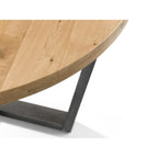 Close-up detail of the smooth round oak tabletop edge and black metal leg frame.