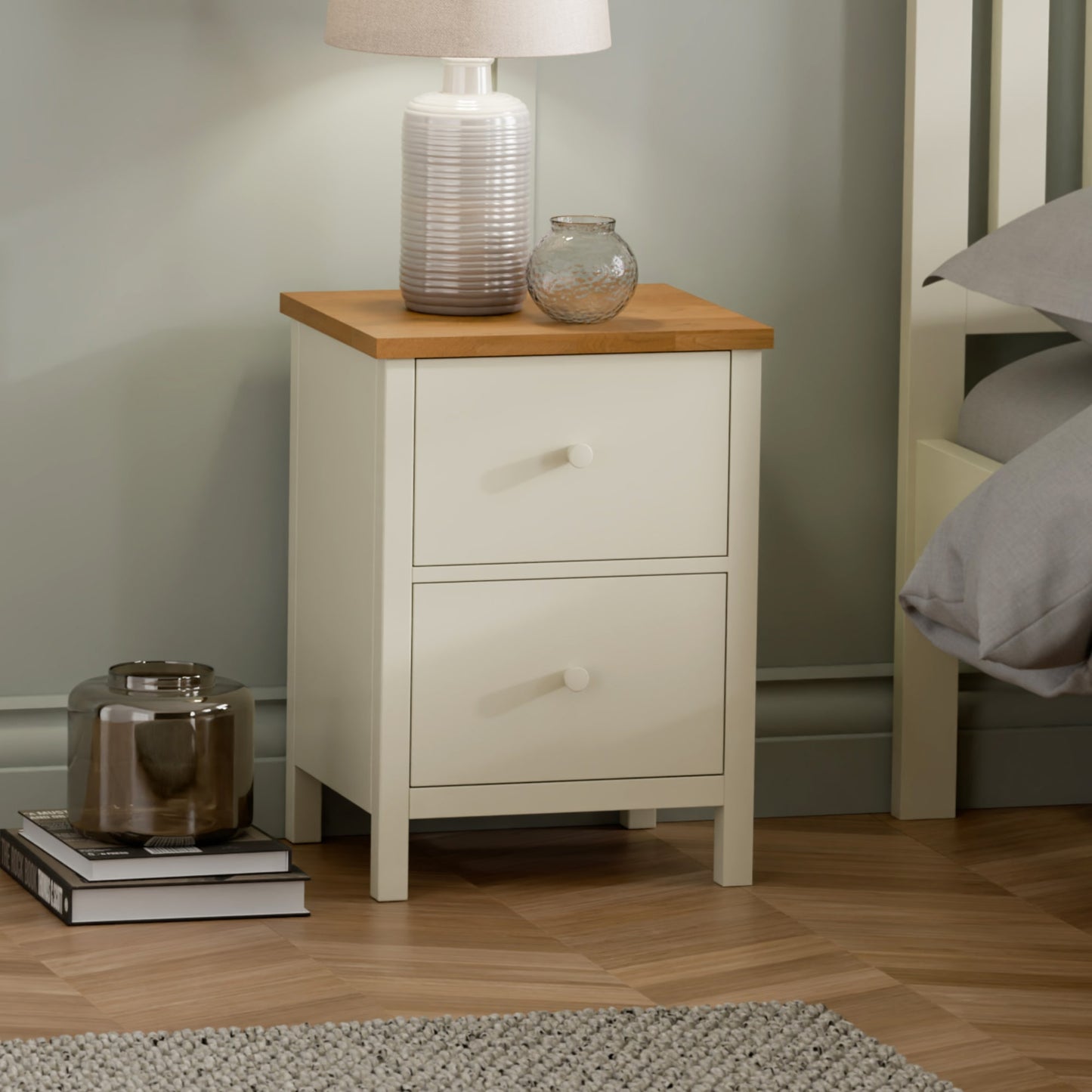 Coxmoor 2 drawer chest in painted ivory with classic oak top styled in a modern bedroom setting.