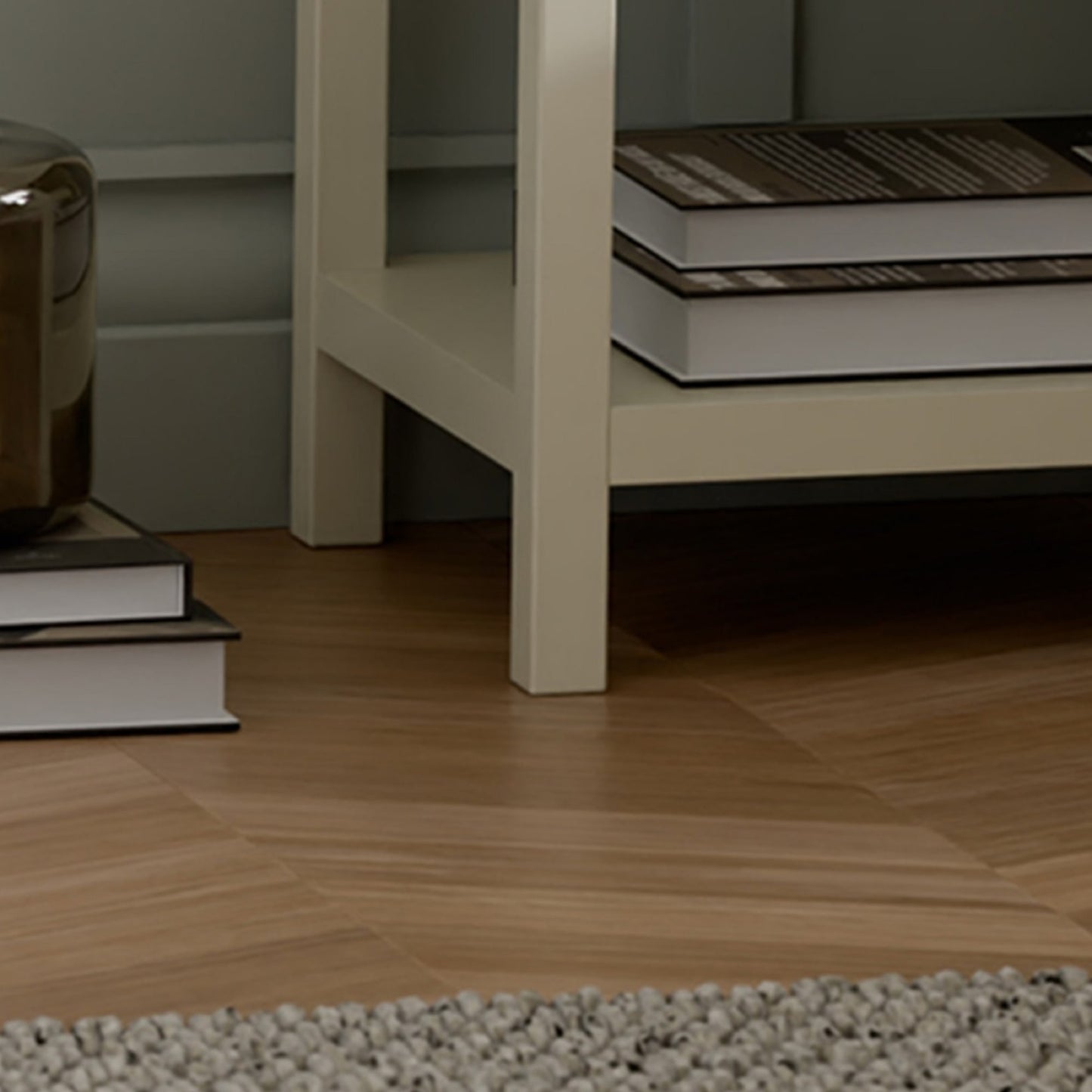 Close-up view of the lower storage shelf, leg frame, and base on the painted ivory Coxmoor bedside unit.