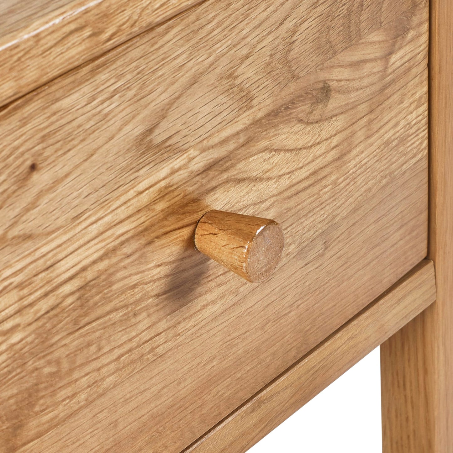 Close-up detail of the wooden drawer knob and natural wood grain on the Coxmoor oak bedside table.