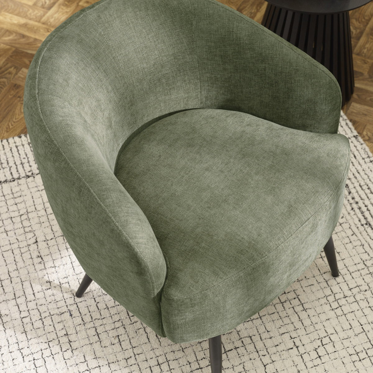 Overhead three-quarter view of the Dahlia curved barrel accent chair in olive green showing the backrest curve