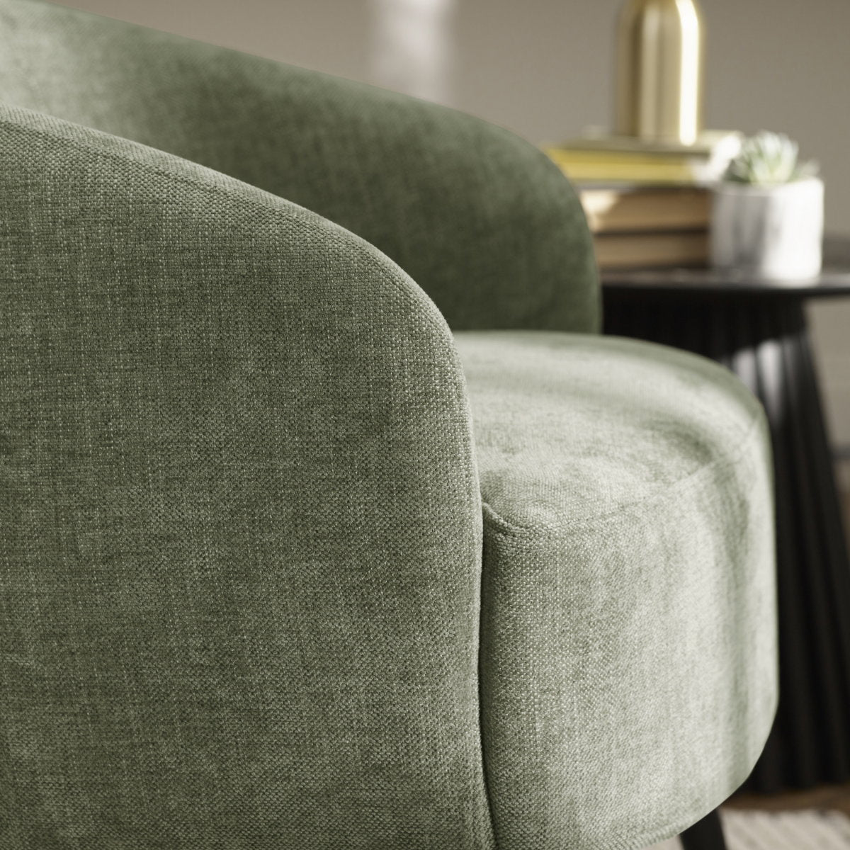 Close-up of the tactile textured faux linen fabric on the backrest of the olive green Dahlia accent chair
