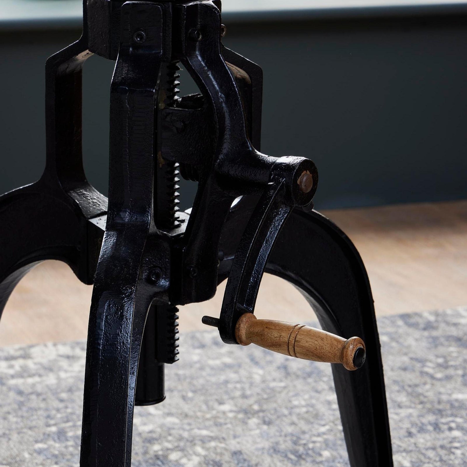 Detailed shot of the black cast iron hand-crank screw mechanism for adjusting the height of the Draftsman table