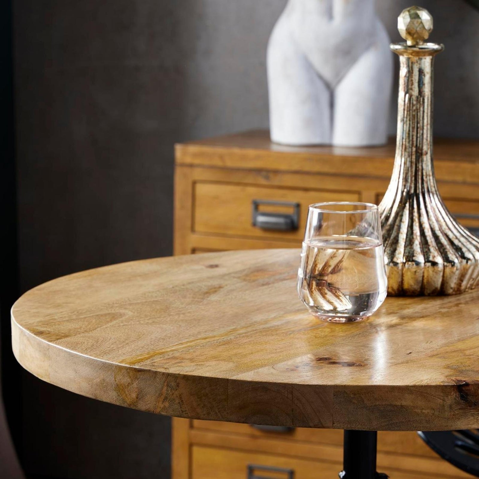Close-up view of the natural solid wood grain tabletop surface on the Draftsman industrial bar table