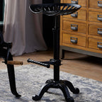 Draftsman adjustable tractor seat bar stool styled next to the matching bar table crank base
