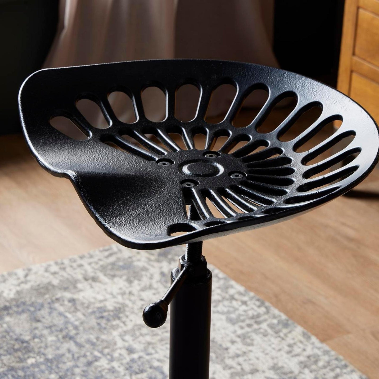 Top view showing the contoured cast iron tractor seat design and vented detailing on the bar stool