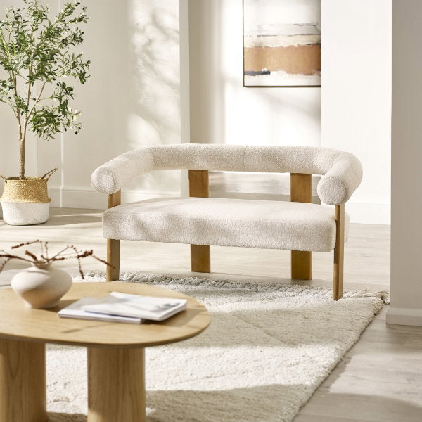 Freya 2 seater fabric sofa styled with neutral rug and table in a modern living room setting