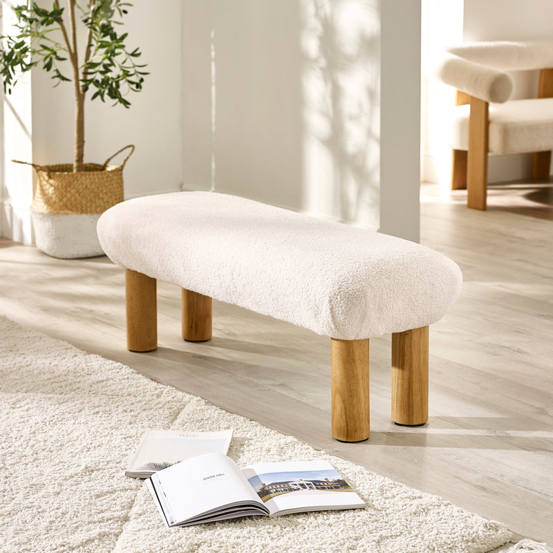 Side view of the Freya low living area bench showing seat cushioning and wooden legs
