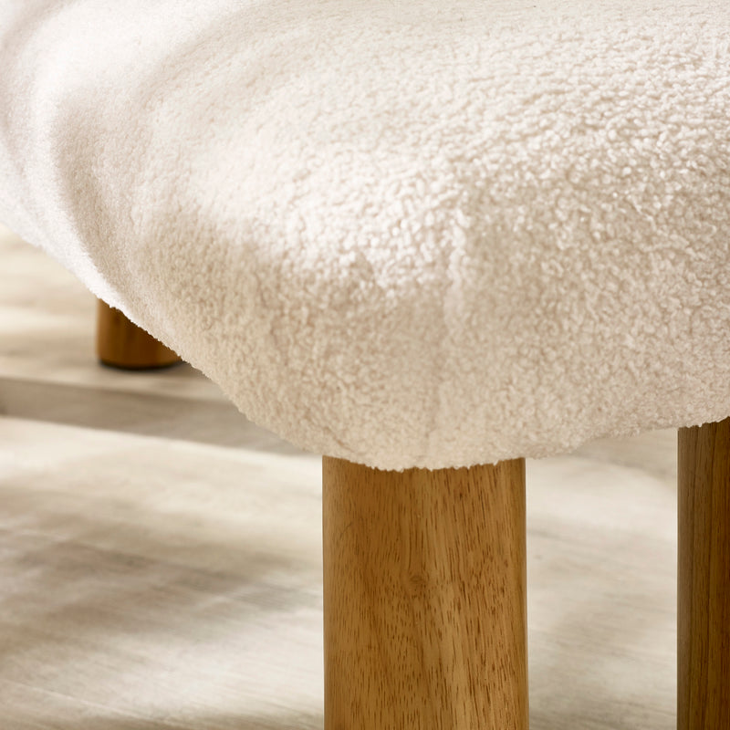 Close-up detail of the neutral fabric upholstery and padded cushion on the Freya bench