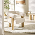 Freya white boucle accent chair styled with a throw blanket in a cozy living area