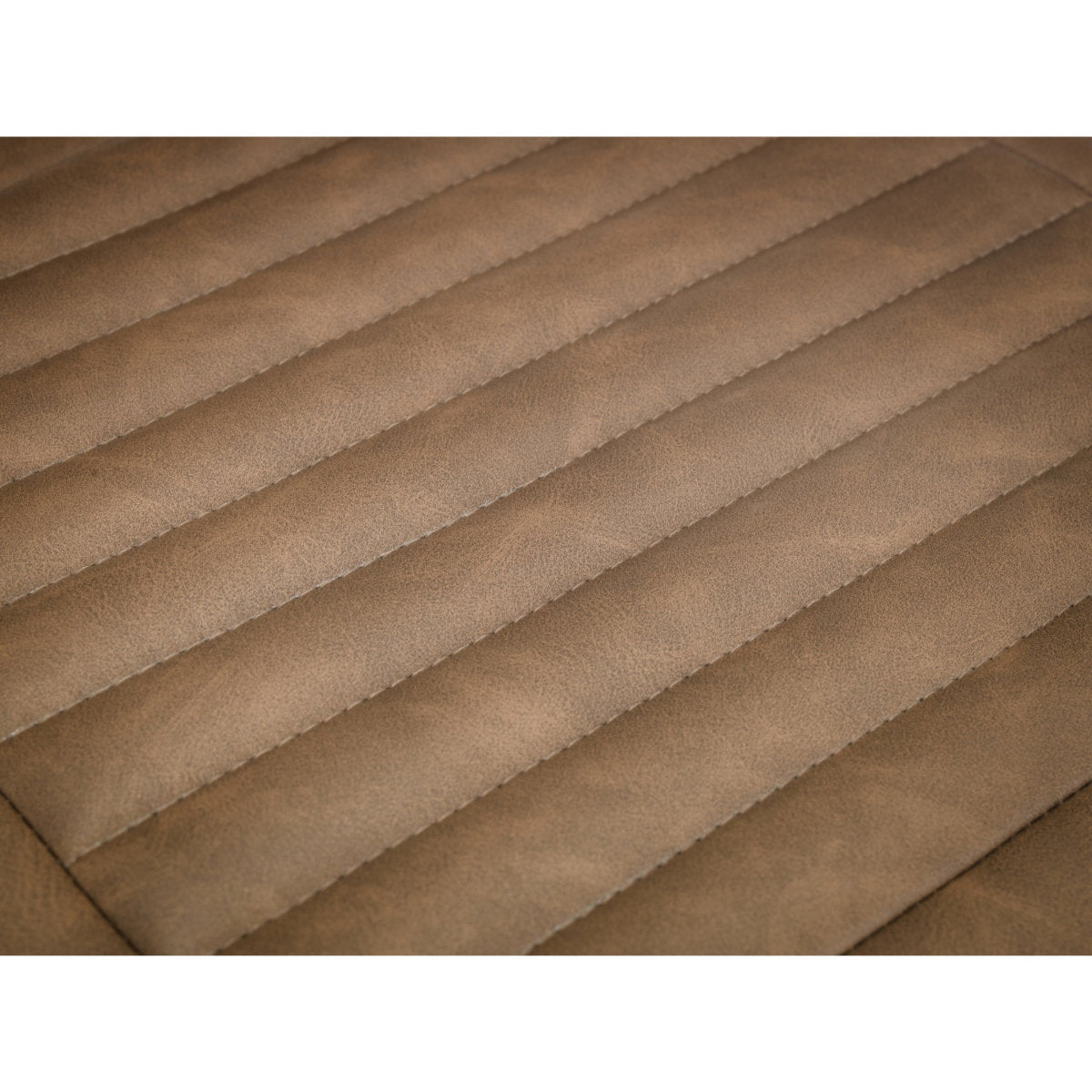 Close-up view of the ribbed quilted stitching on the vintage brown faux leather seat cushion.