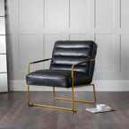 Giorgio faux leather accent chair with gold legs styled as an accent chair in a modern room
