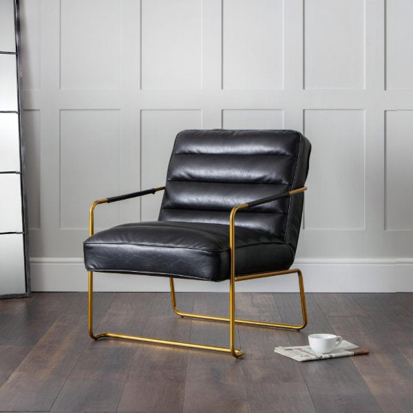 Giorgio faux leather accent chair with gold legs styled as an accent chair in a modern room