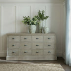 Haldon wooden 12 drawer chest styled in a living room with decorative vases