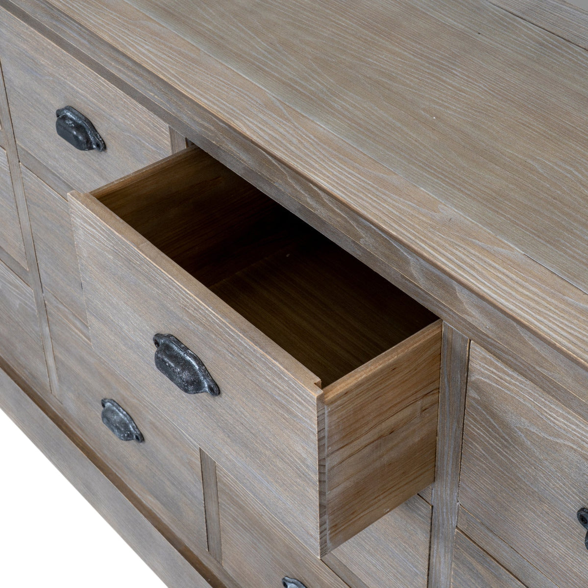 Close-up detail view showing an open drawer with metal cup handle pull on the Haldon wooden chest