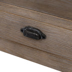 Close-up view of the dark antique metal cup handle and natural wood grain on the Haldon side table drawer