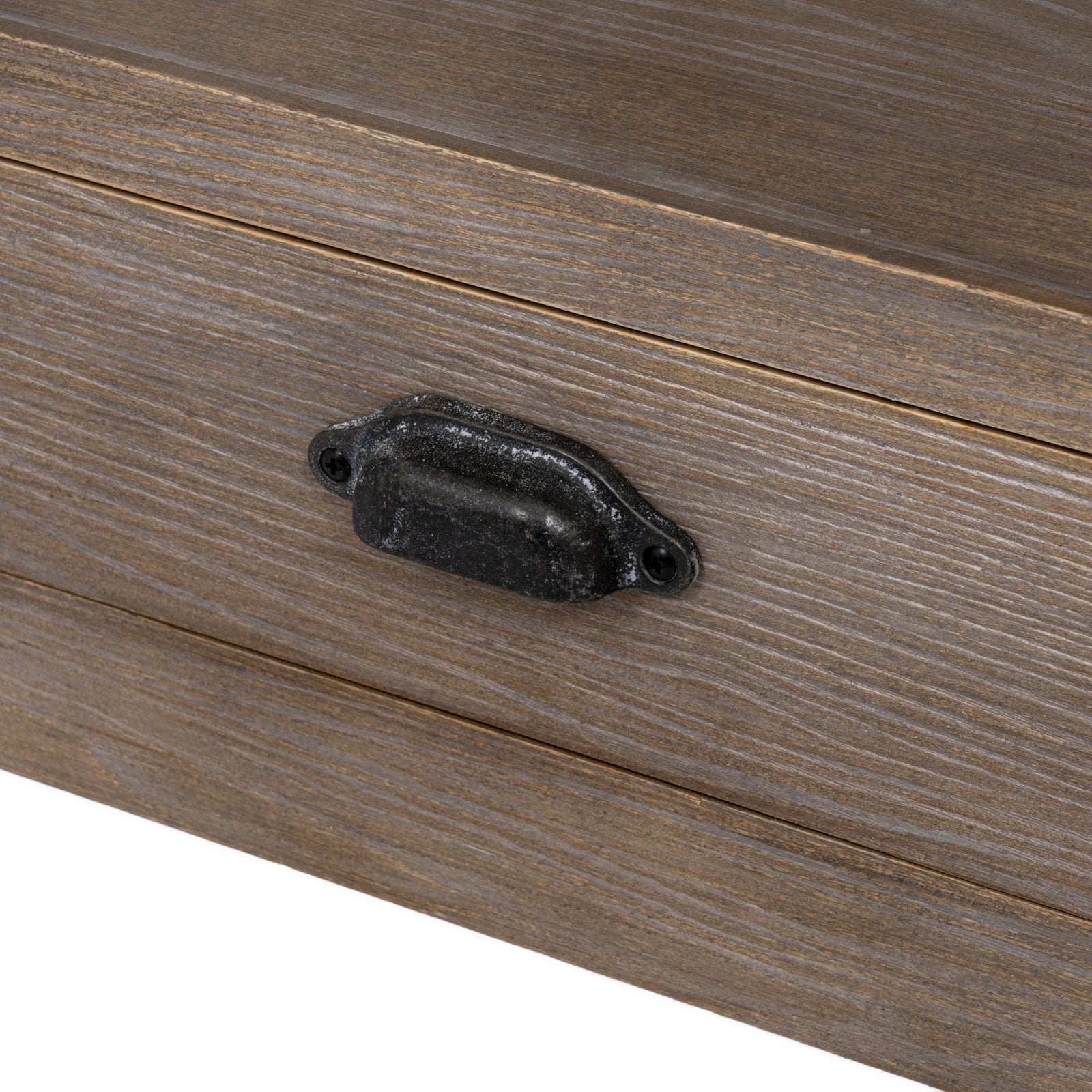 Close-up view of the dark antique metal cup handle and natural wood grain on the Haldon side table drawer