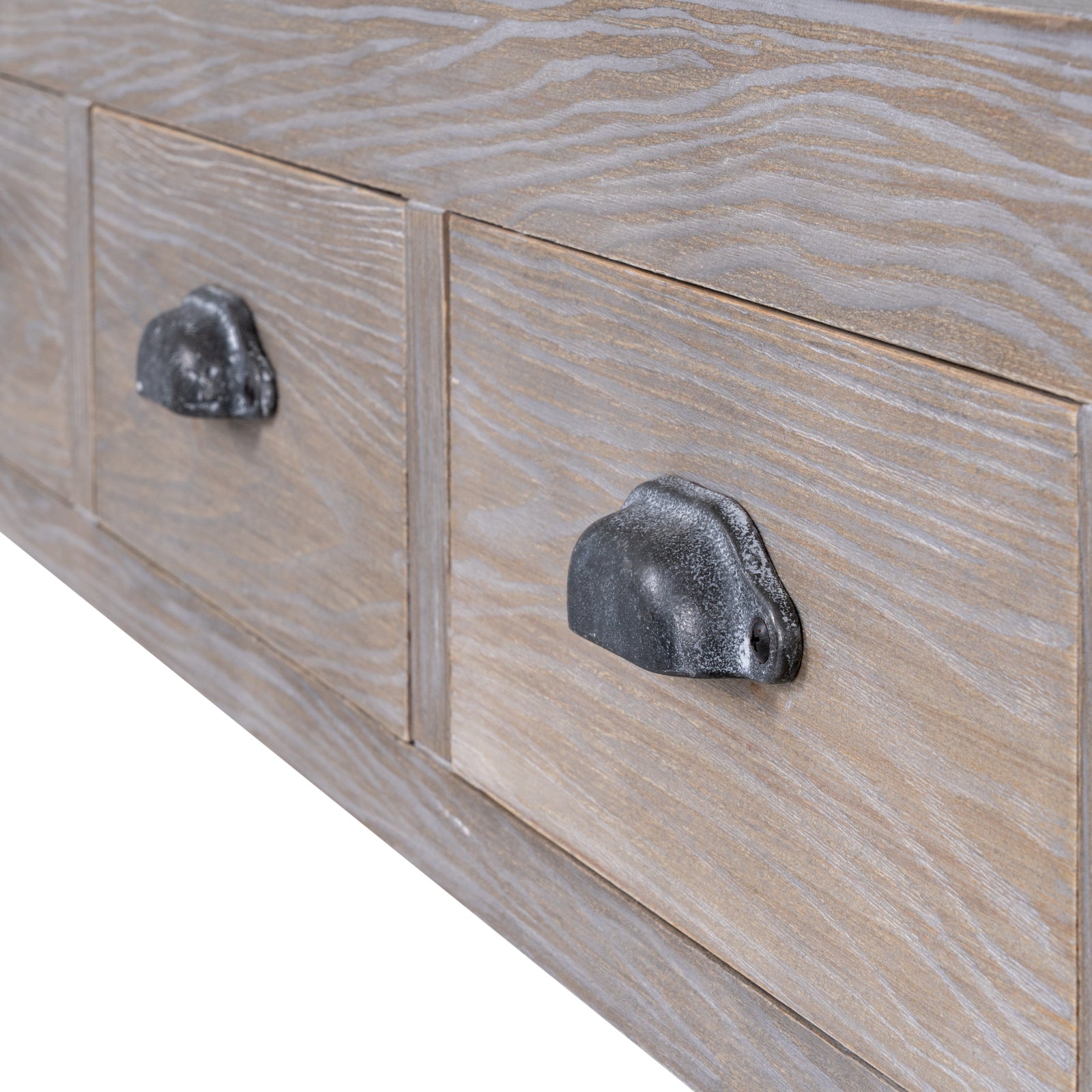 Close-up shot showing the dark antique metal cup handle pulls and natural wood grain on the Haldon console table drawers