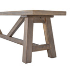 Close-up shot of the sturdy angled trestle legs and cross-support beam on the Haldon wooden dining bench
