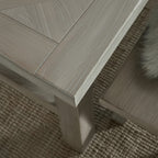 Close-up shot highlighting the geometric parquetry wood detail and corner craftsmanship on the Haldon dining tabletop