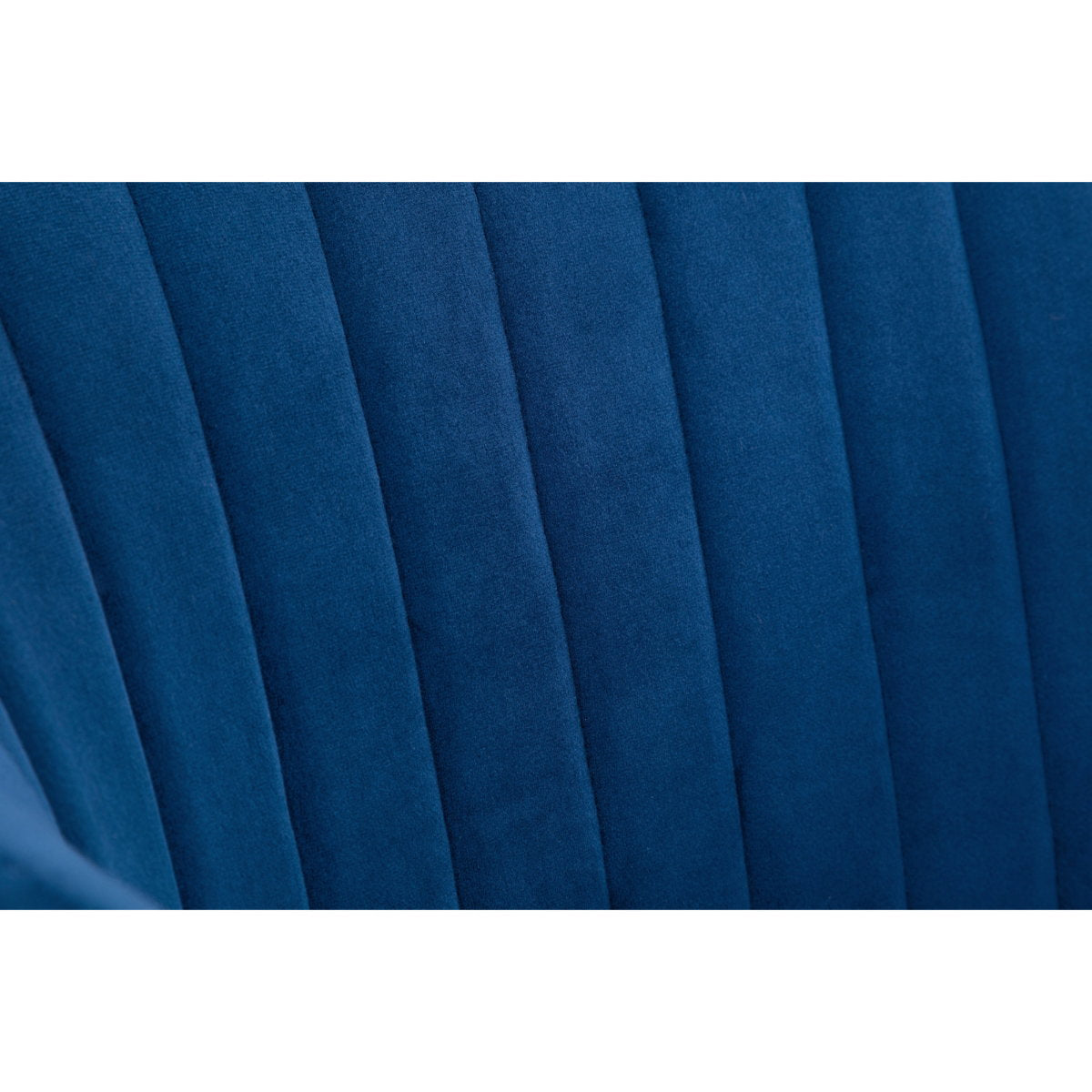 Close-up view of the vertical channel stitching on the plush blue velvet backrest.